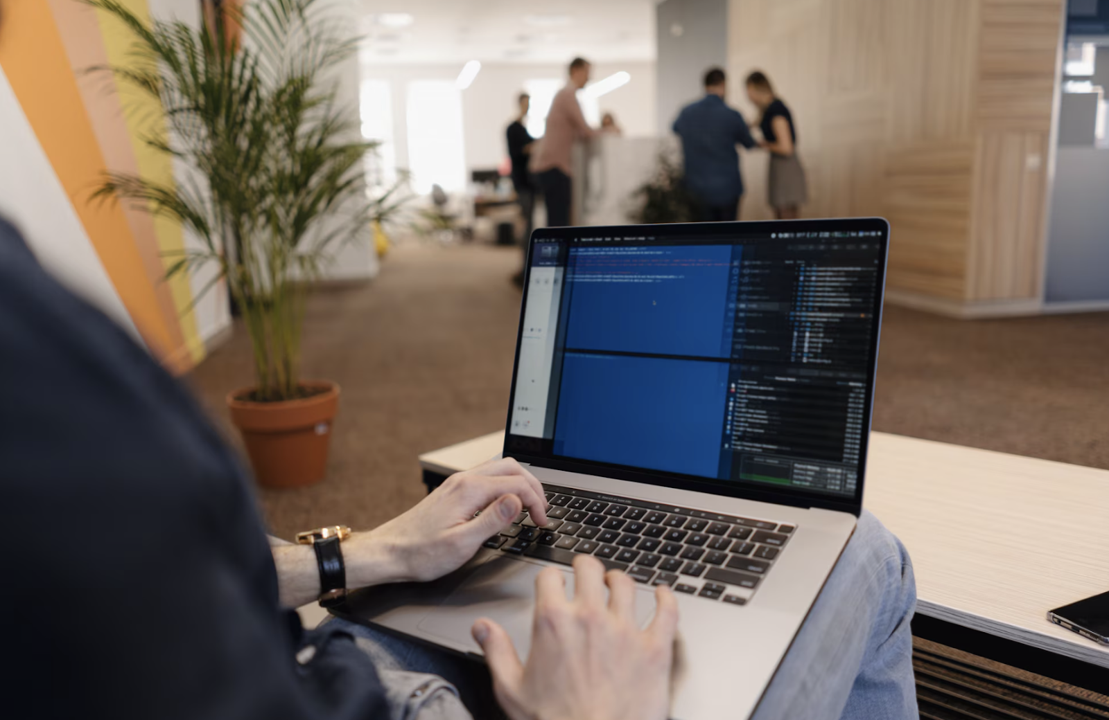 A man writing a code on the laptop